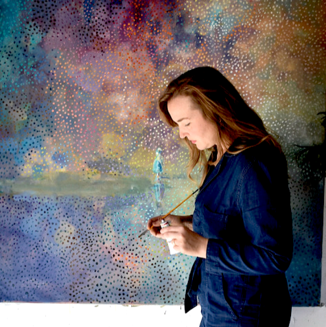 Person painting a colorful abstract mural with a brush.
