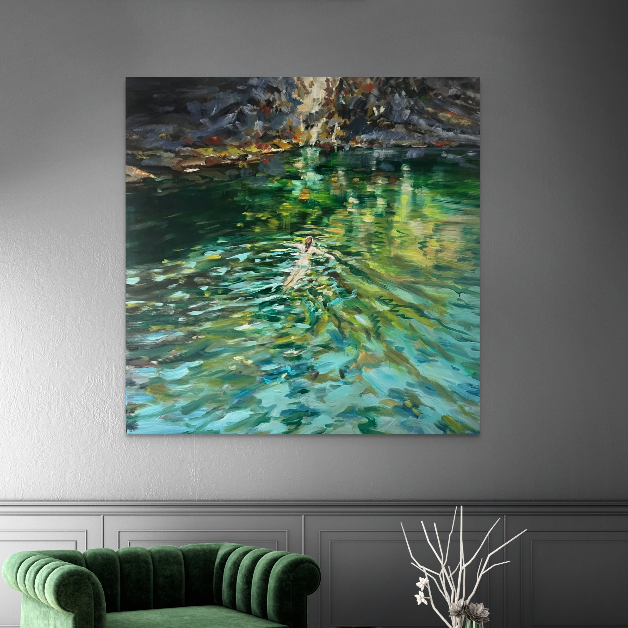 Painting of a person swimming in water on a wall above a green sofa and coffee table.
