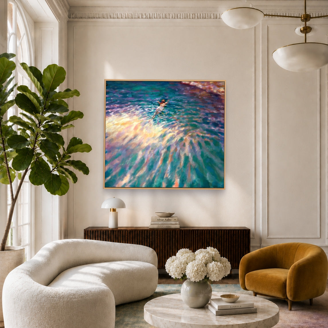A framed abstract painting of rippling water in teal, blue, purple, and gold hangs on a cream paneled wall in a modern living room with a curved white sofa, a yellow armchair, and a round marble coffee table.
